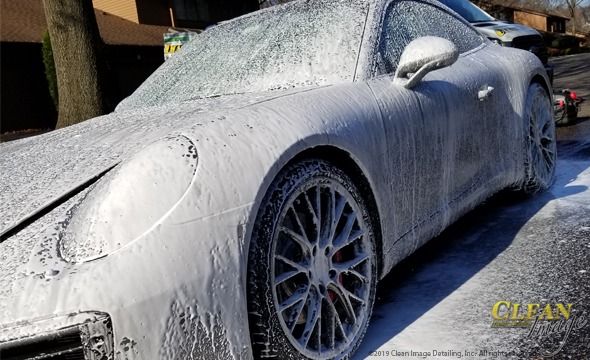 Black Porsche 911 with foam bath.