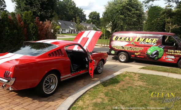 Red mustang convertible with white stripes getting full detailed.
