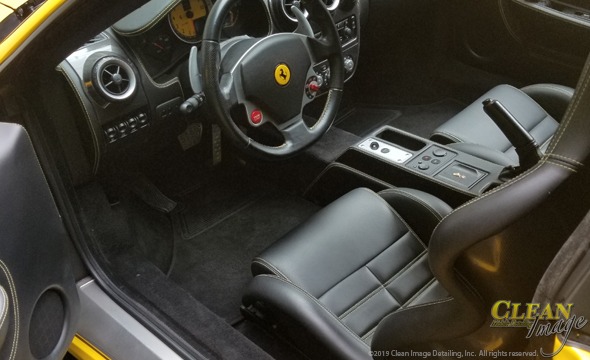 Yellow Ferrari's black leather interior all perfect looking.