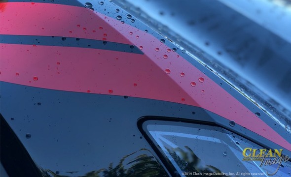 Black Corvette with dual red fender stripes.