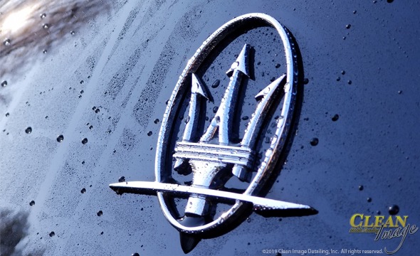 Black Maserati logo dripping wet.