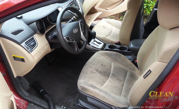 Red Hyundai with tan interior all filthy and dirty.