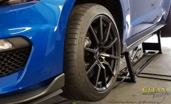 Blue Mustang Cobra black rims.