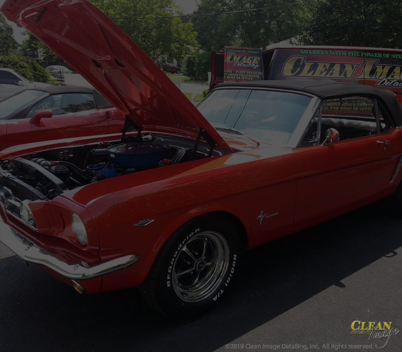Red convertible mustang with hood up after Executive Detailing.