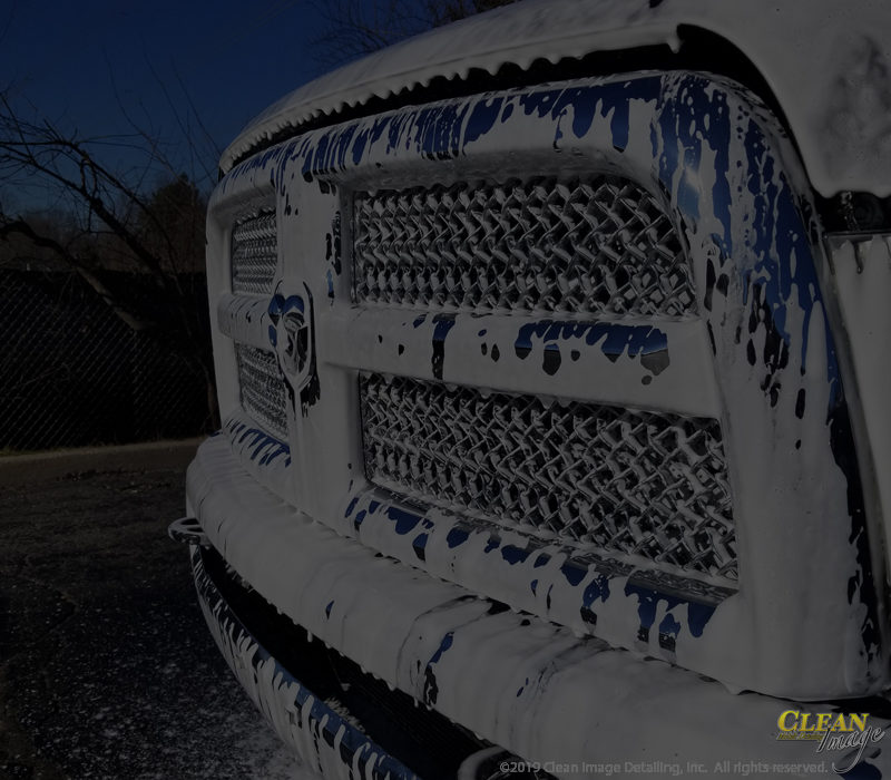 Mobile Detailing: RAM truck grille in foam bath.