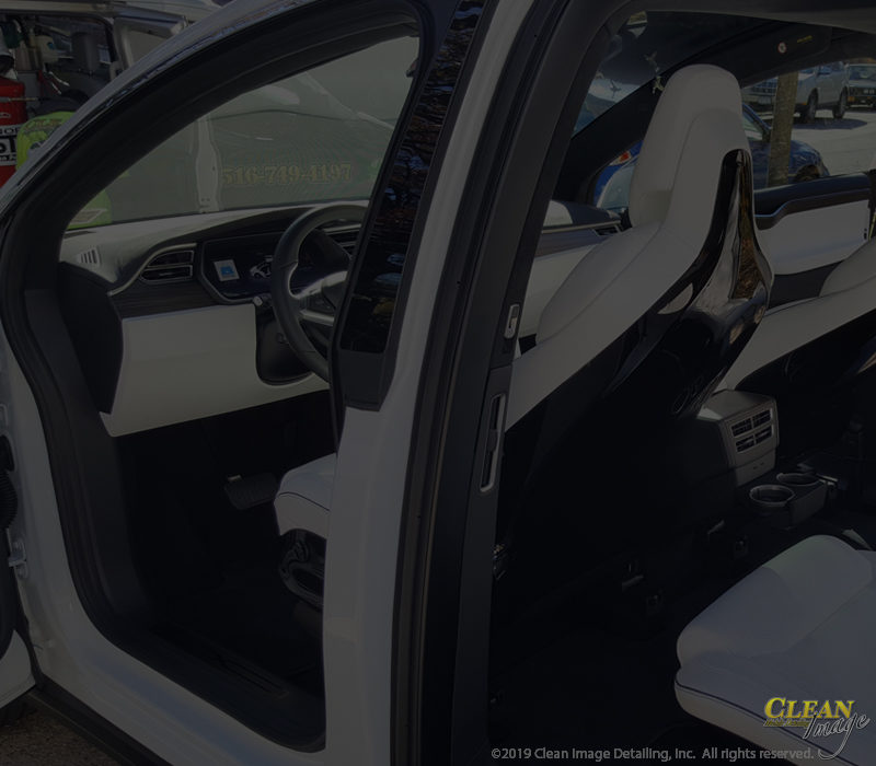 White and black Tesla interior after interior detailing.
