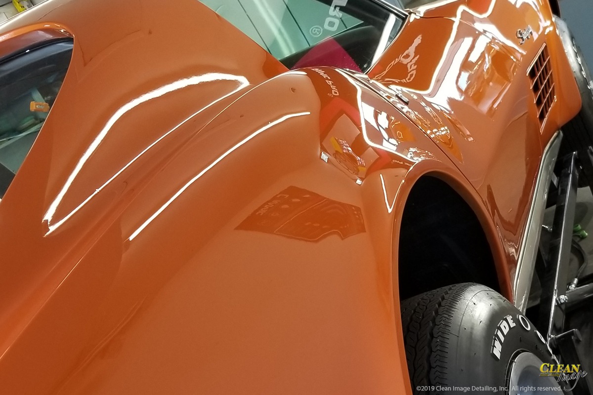 Orange Corvette Stingray after paint correction services are applied.